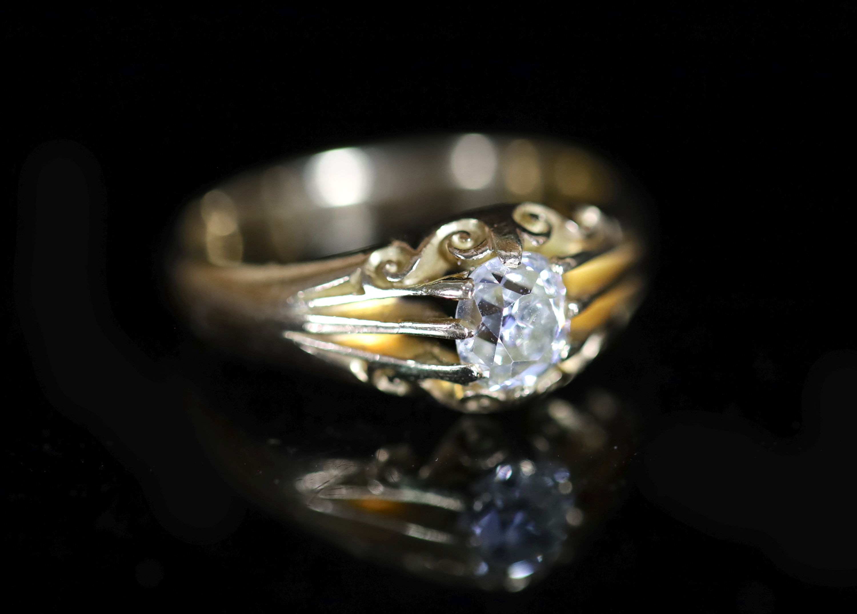An early 20th century 18ct gold and claw set solitaire diamond ring